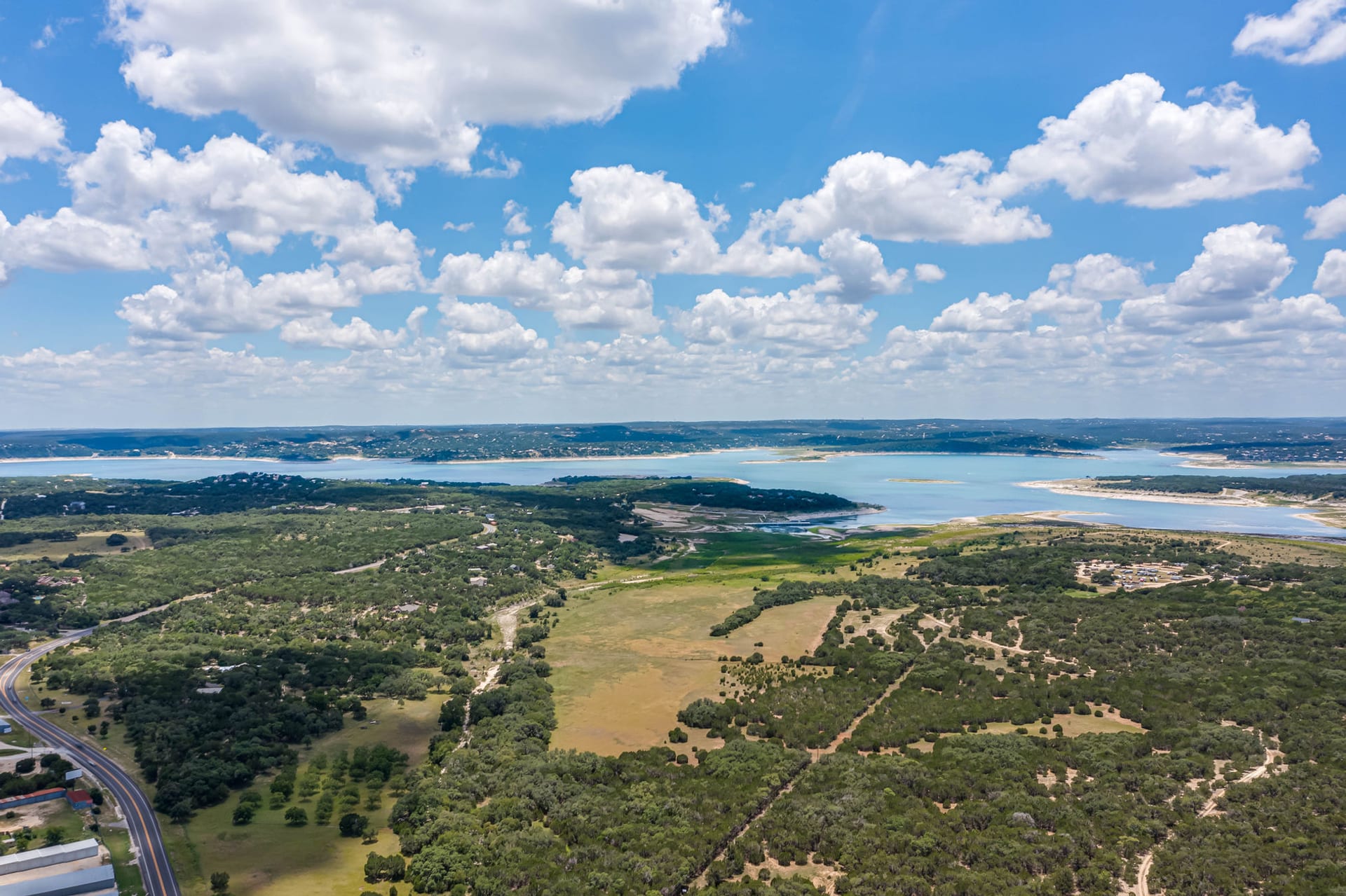 Aerial view of Hill Country woodland with Canyon Lake on the horizon